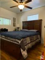 Bedroom featuring a ceiling fan and wood finished floors