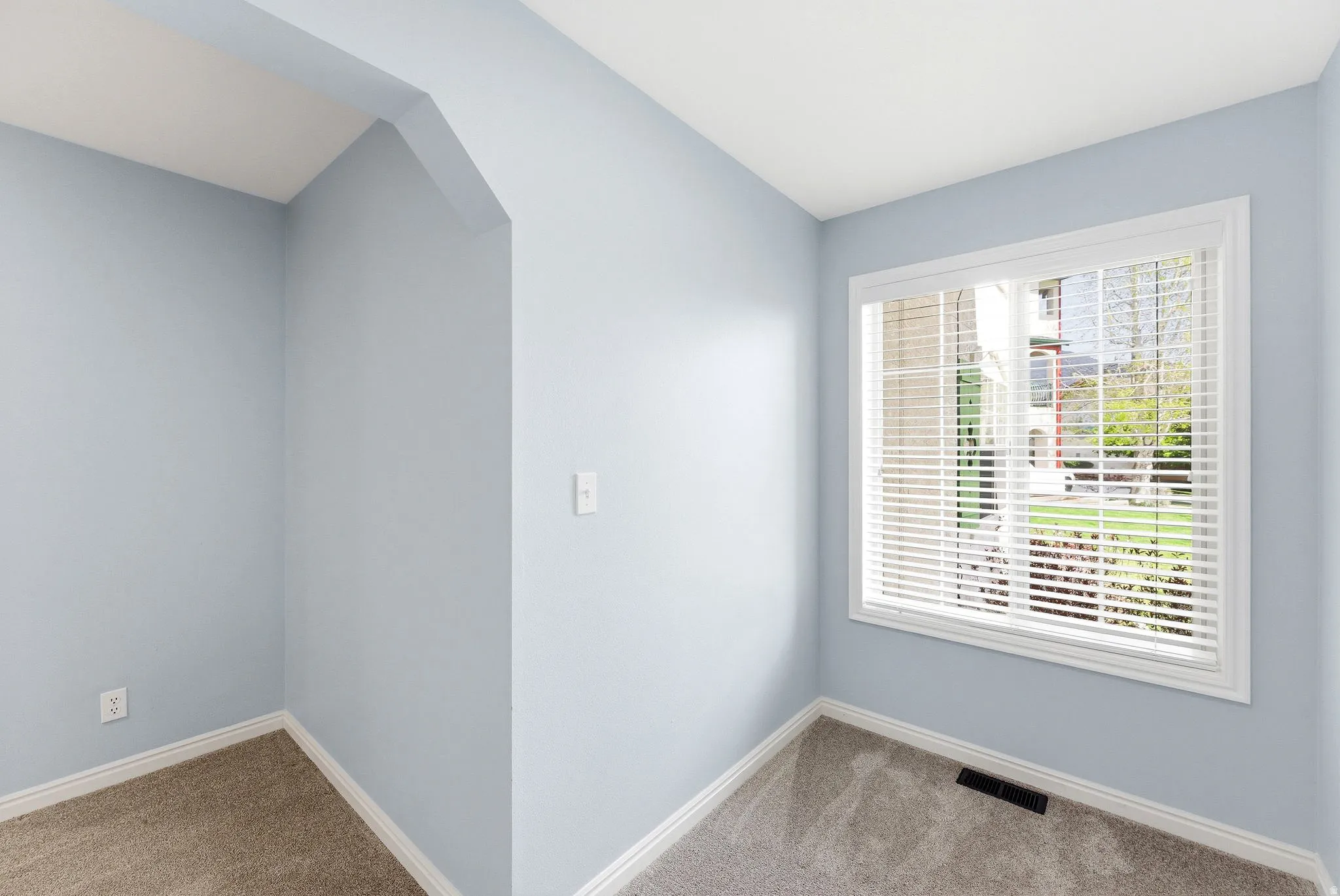A spacious bedroom with a connected open area that adds versatility for work, hobbies, or extra storage.