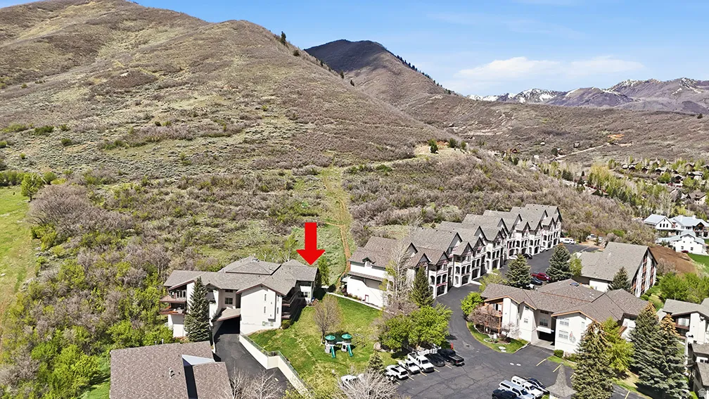 Swiss Oaks real estate drone view showing condo buildings, parking, and landscaped grounds