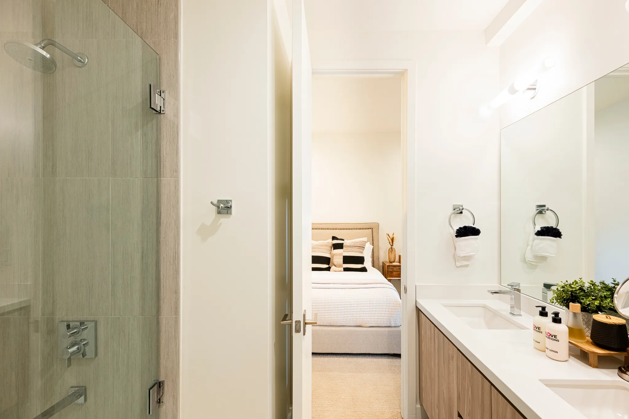 Full bathroom featuring connected bathroom, double vanity, and shower / tub combination
