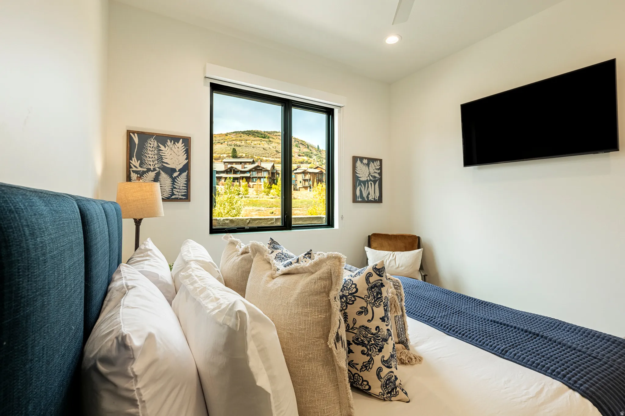 Bedroom with a ceiling fan and recessed lighting