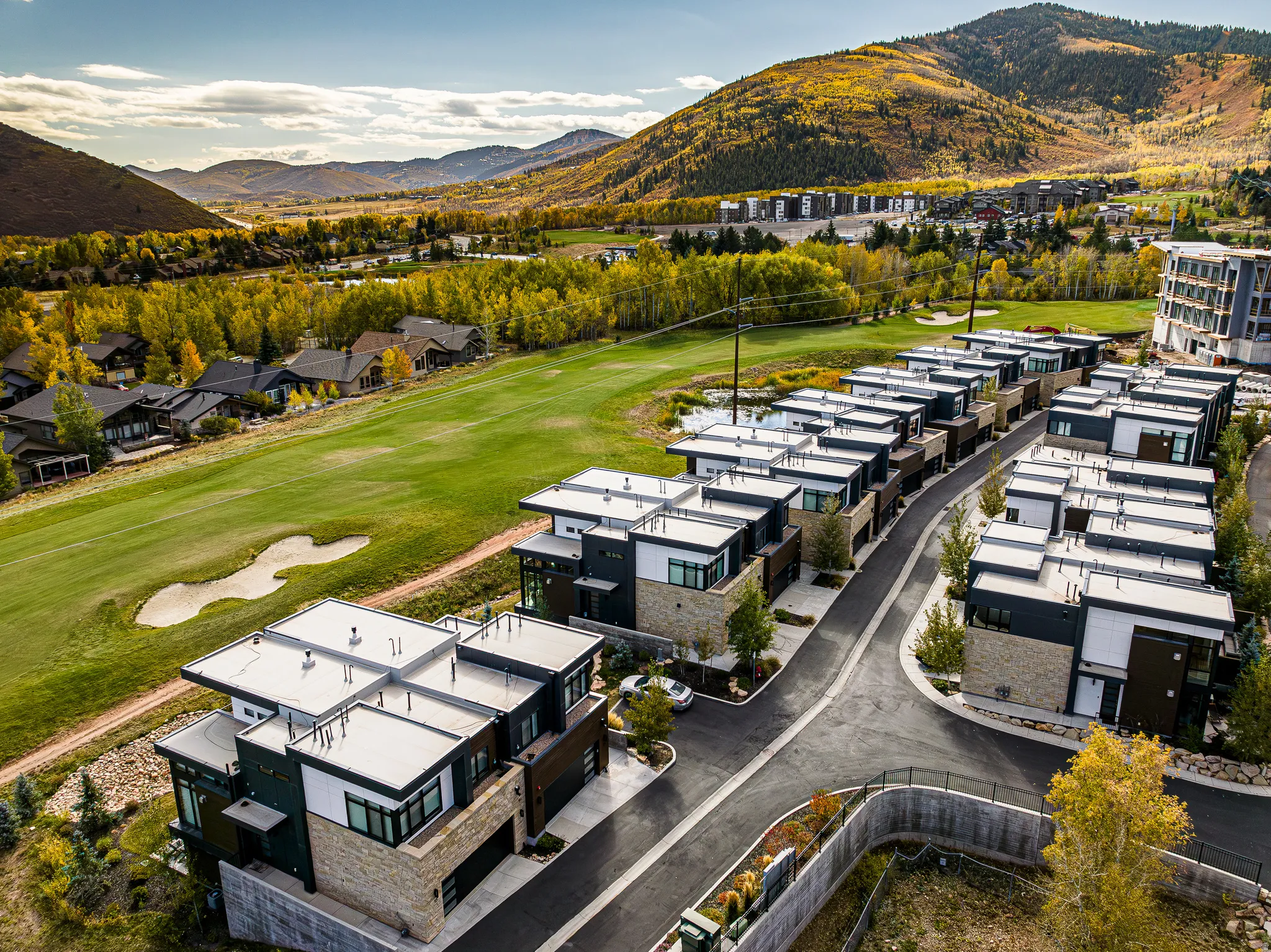 Aerial view of a mountain backdrop and a golf course