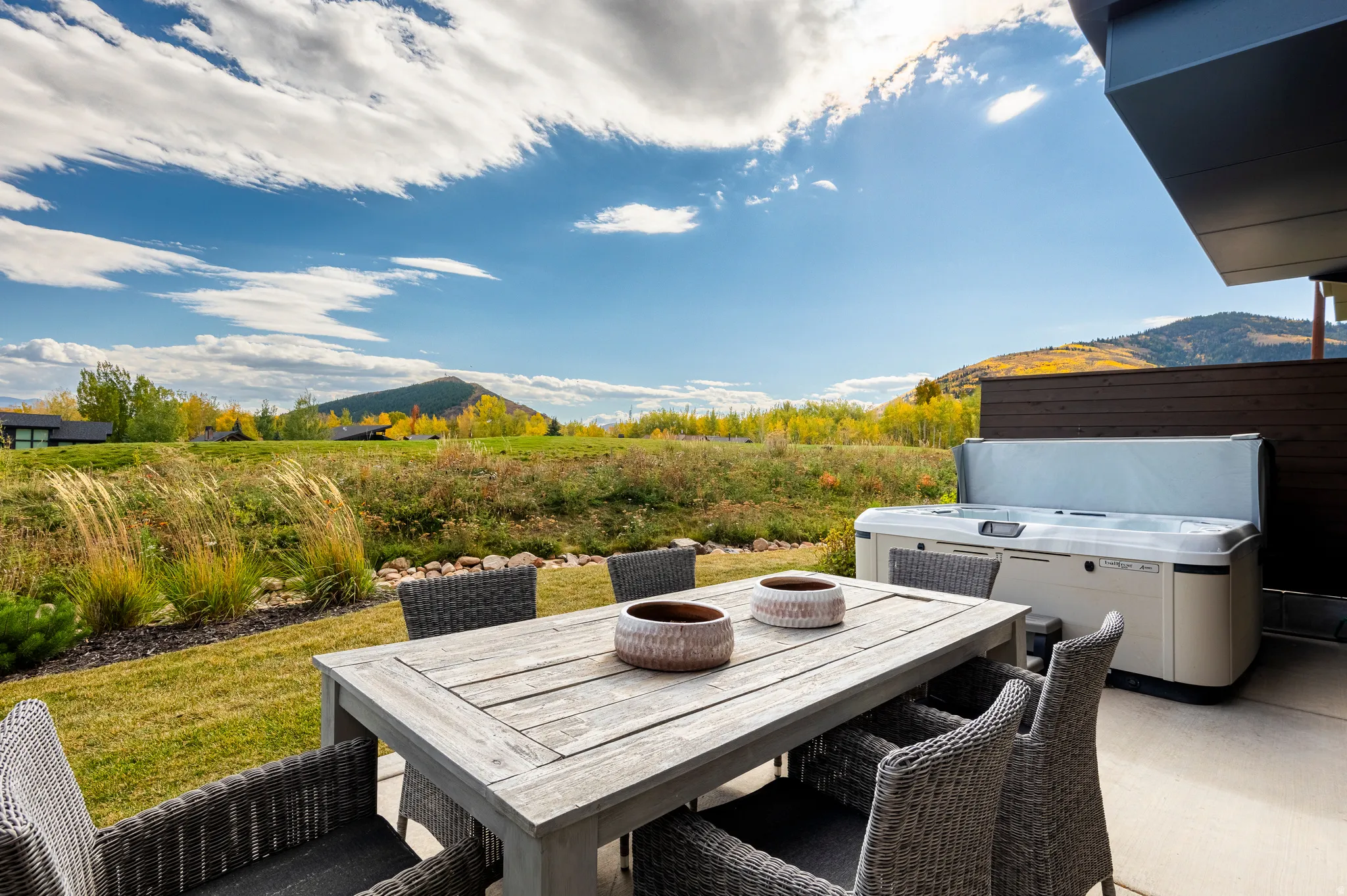 View of patio / terrace featuring a mountain view, outdoor dining space, and a hot tub
