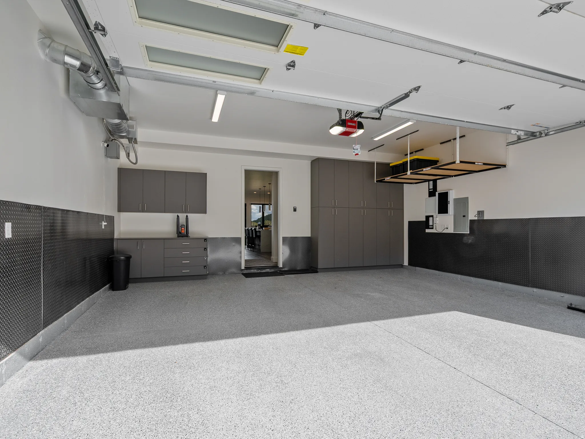 Garage with electric panel and a garage door opener