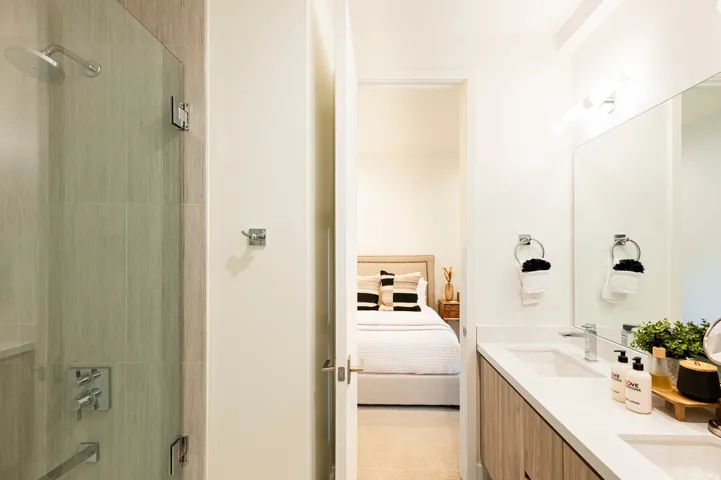 Full bathroom featuring connected bathroom, double vanity, and shower / tub combination