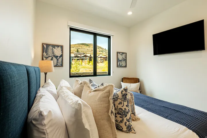 Bedroom with a ceiling fan and recessed lighting