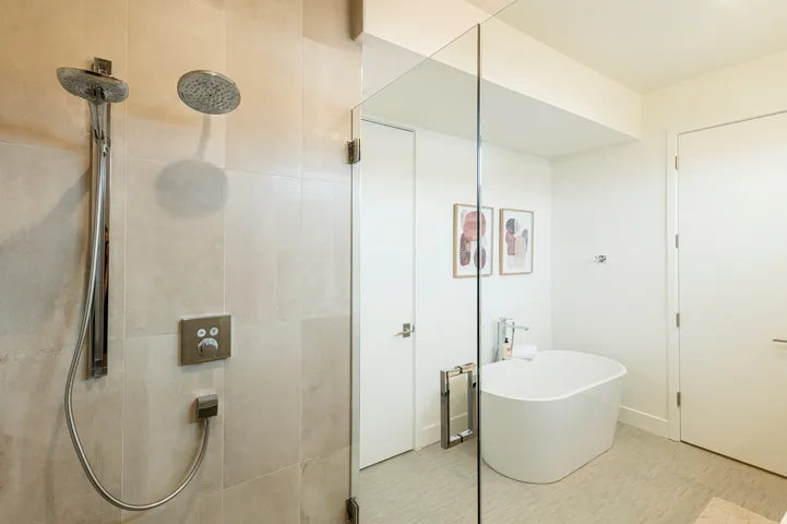 Bathroom featuring a freestanding tub and a tile shower