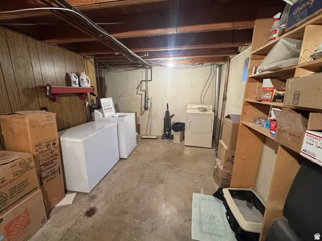Unfinished basement featuring separate washer and dryer