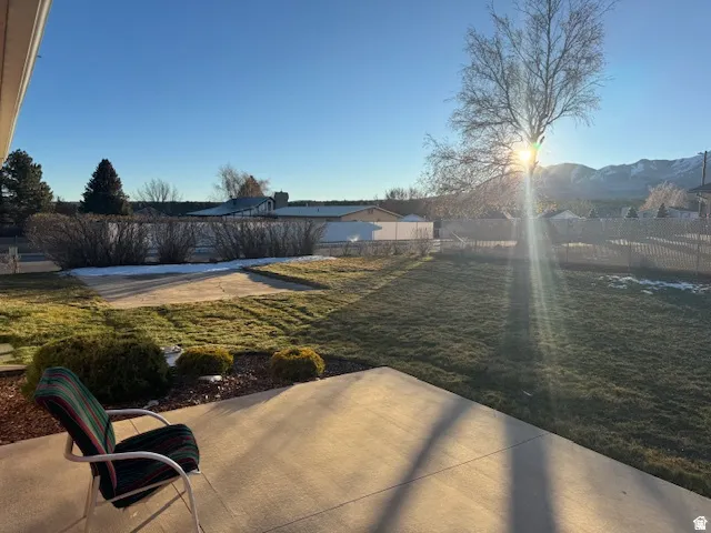 Fenced backyard with a patio and a mountain view