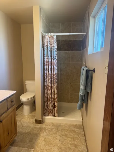 Bathroom featuring vanity and a stall shower