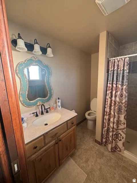 Bathroom with vanity, a stall shower, and light tile patterned floors