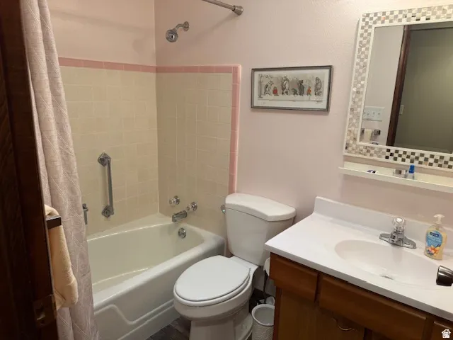 Bathroom with vanity and shower / tub combo with curtain