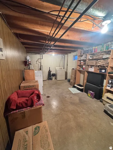 Unfinished below grade area featuring separate washer and dryer