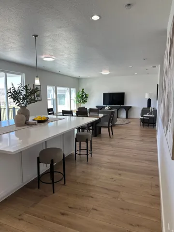 Dining space with light wood finished floors and a textured ceiling