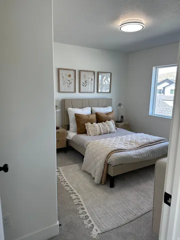 Bedroom with carpet flooring and a textured ceiling