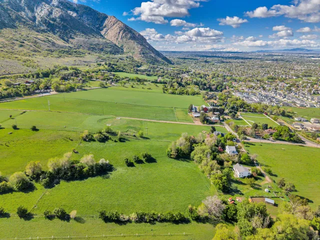 Aerial view of sparsely populated area with mountains and a pastoral area