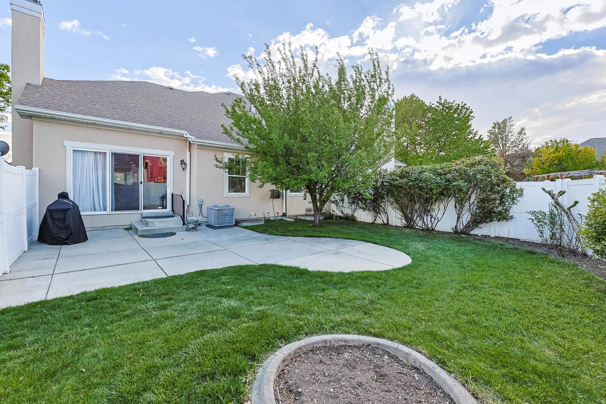 Back of house featuring a fenced backyard, a patio area, stucco siding, a chimney, and a shingled roof