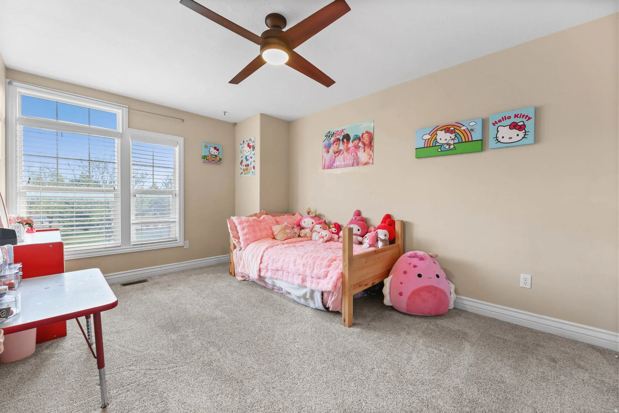 Bedroom with light colored carpet and a ceiling fan