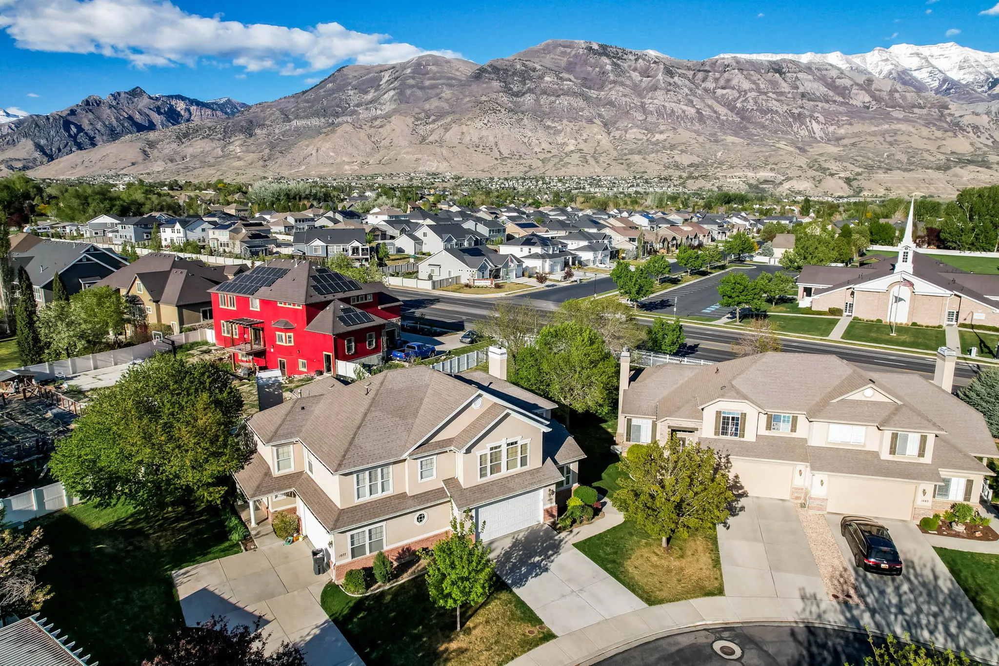 Aerial perspective of suburban area featuring a mountainous background