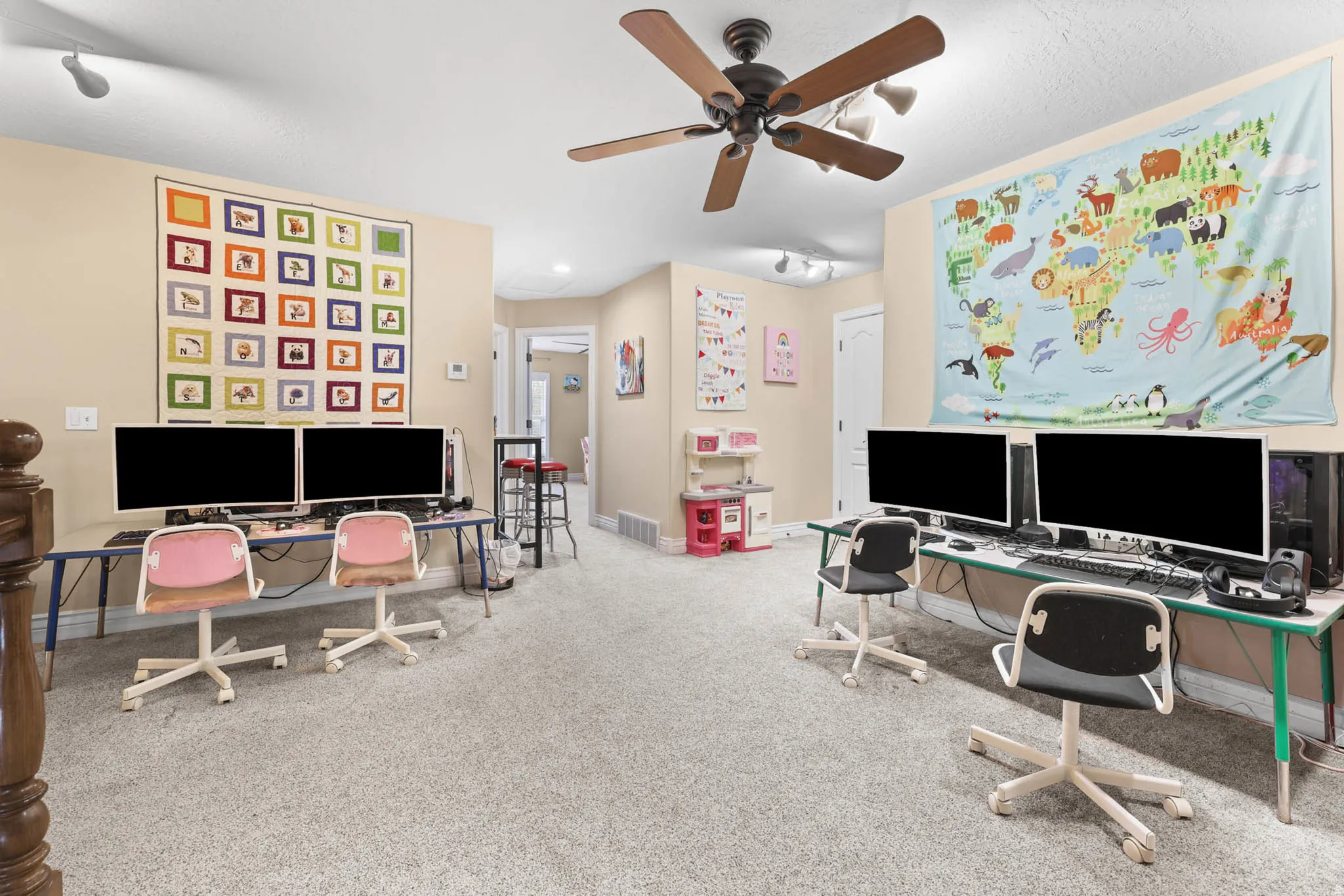 Office area featuring light colored carpet and ceiling fan