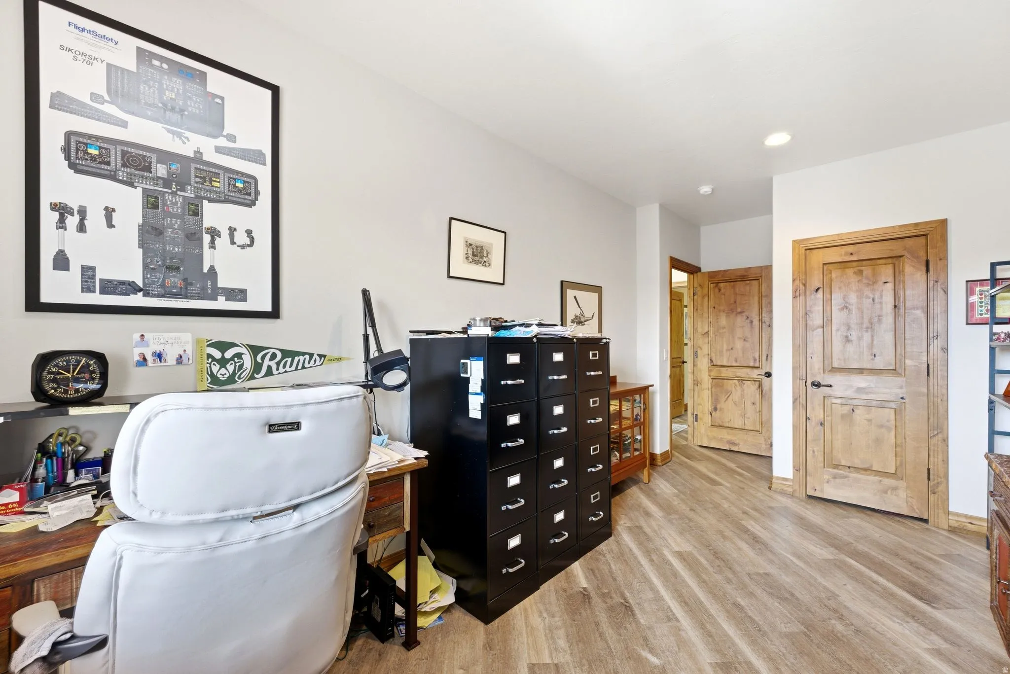 Office space with light wood-style flooring and recessed lighting