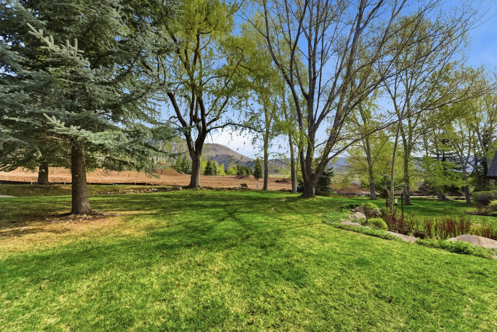 View of green lawn featuring a mountain view
