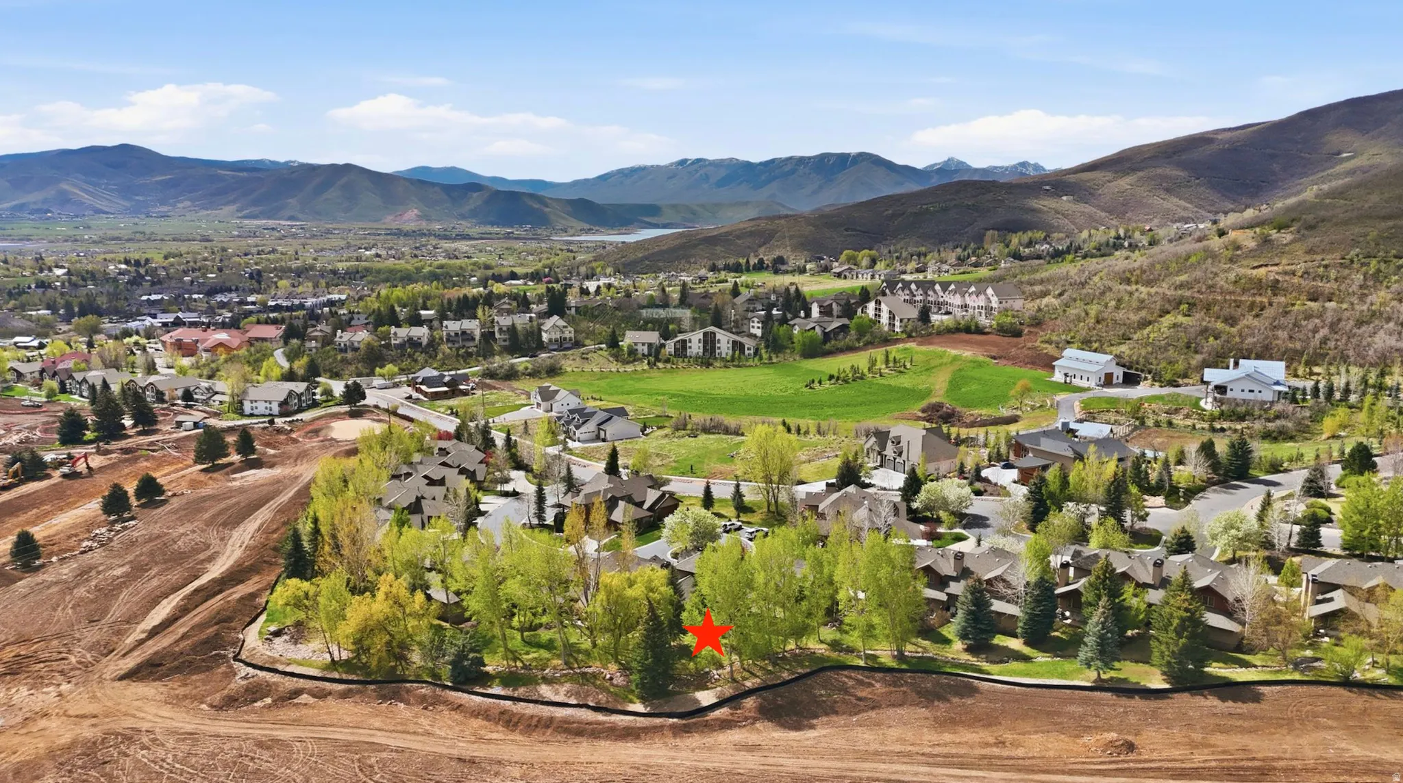 Aerial perspective of suburban area with a mountainous background