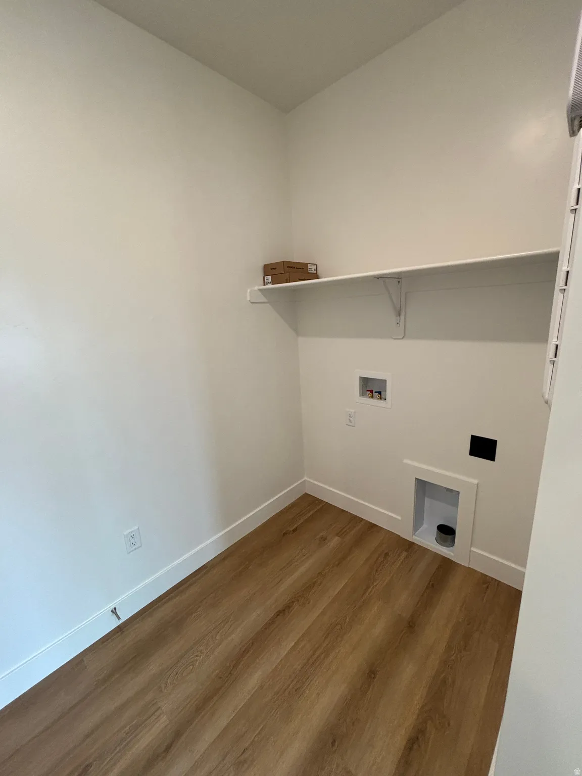 Laundry room with wood finished floors and washer hookup