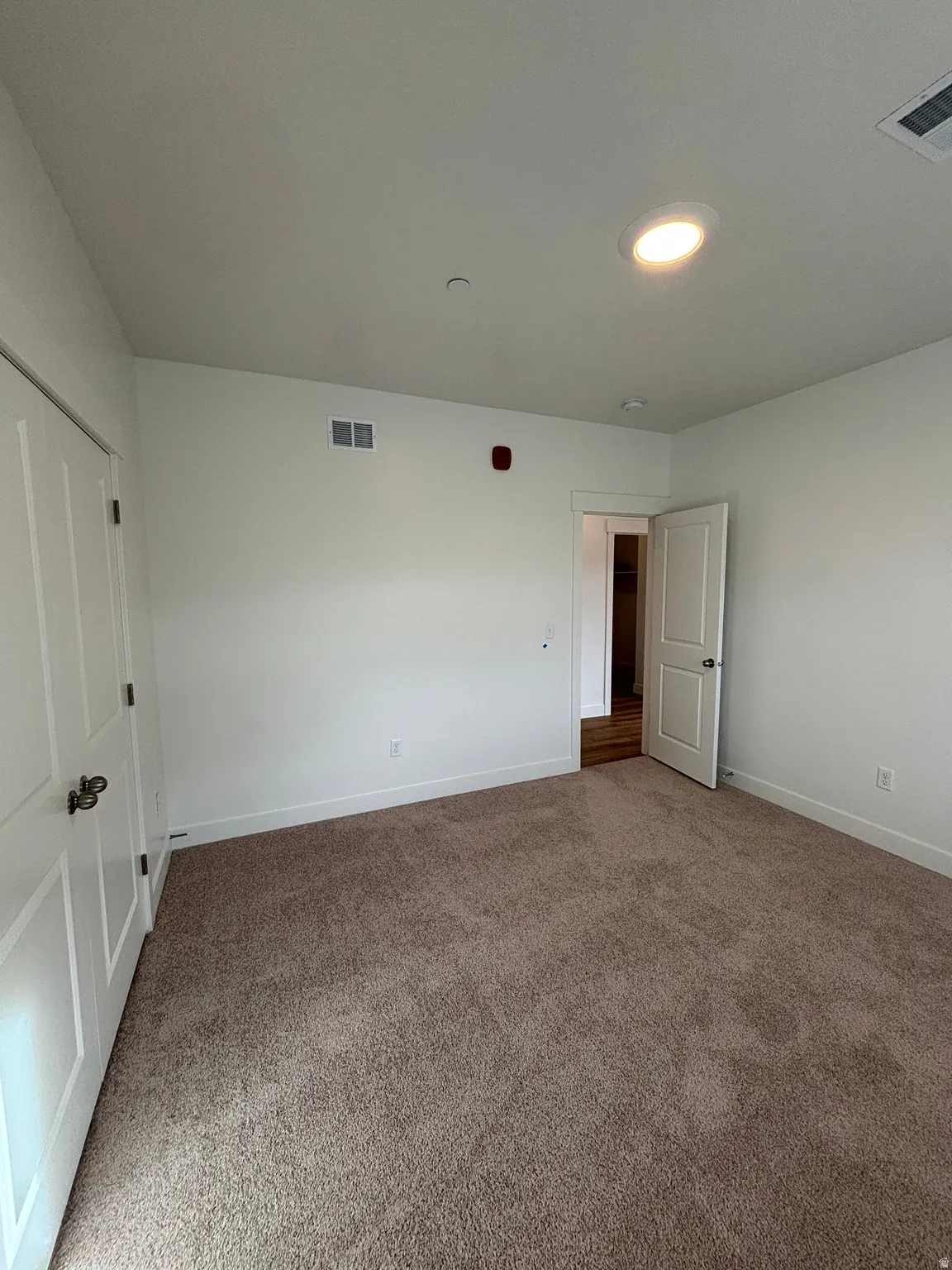 Unfurnished bedroom featuring a closet and carpet
