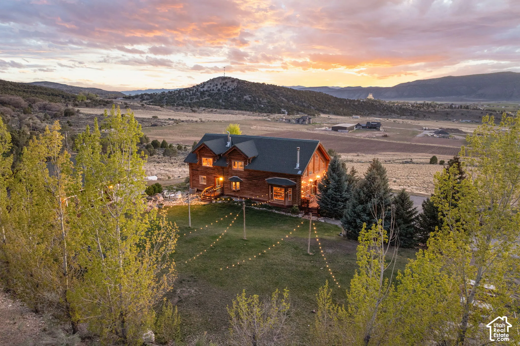 Back of property with a mountain view and a lawn