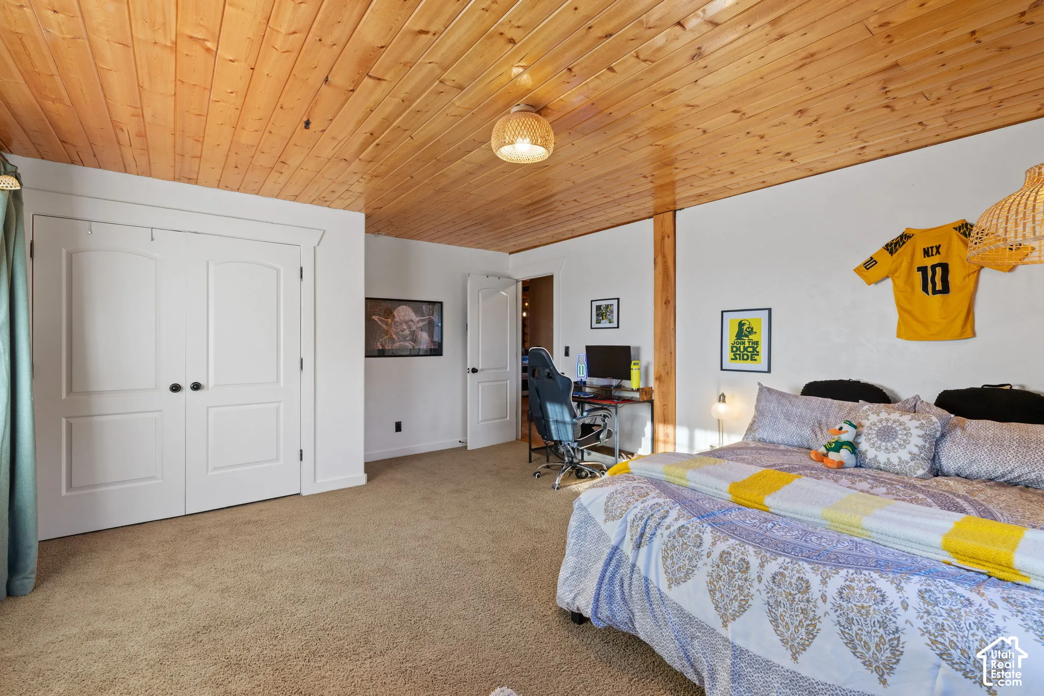 Carpeted bedroom featuring a desk, a closet, and wood ceiling