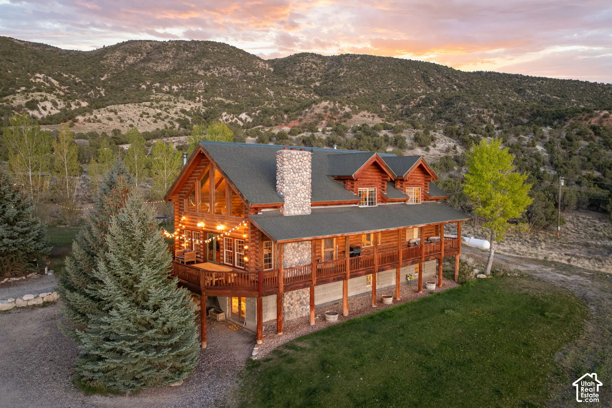 Front view of custom log home with BLM land behind