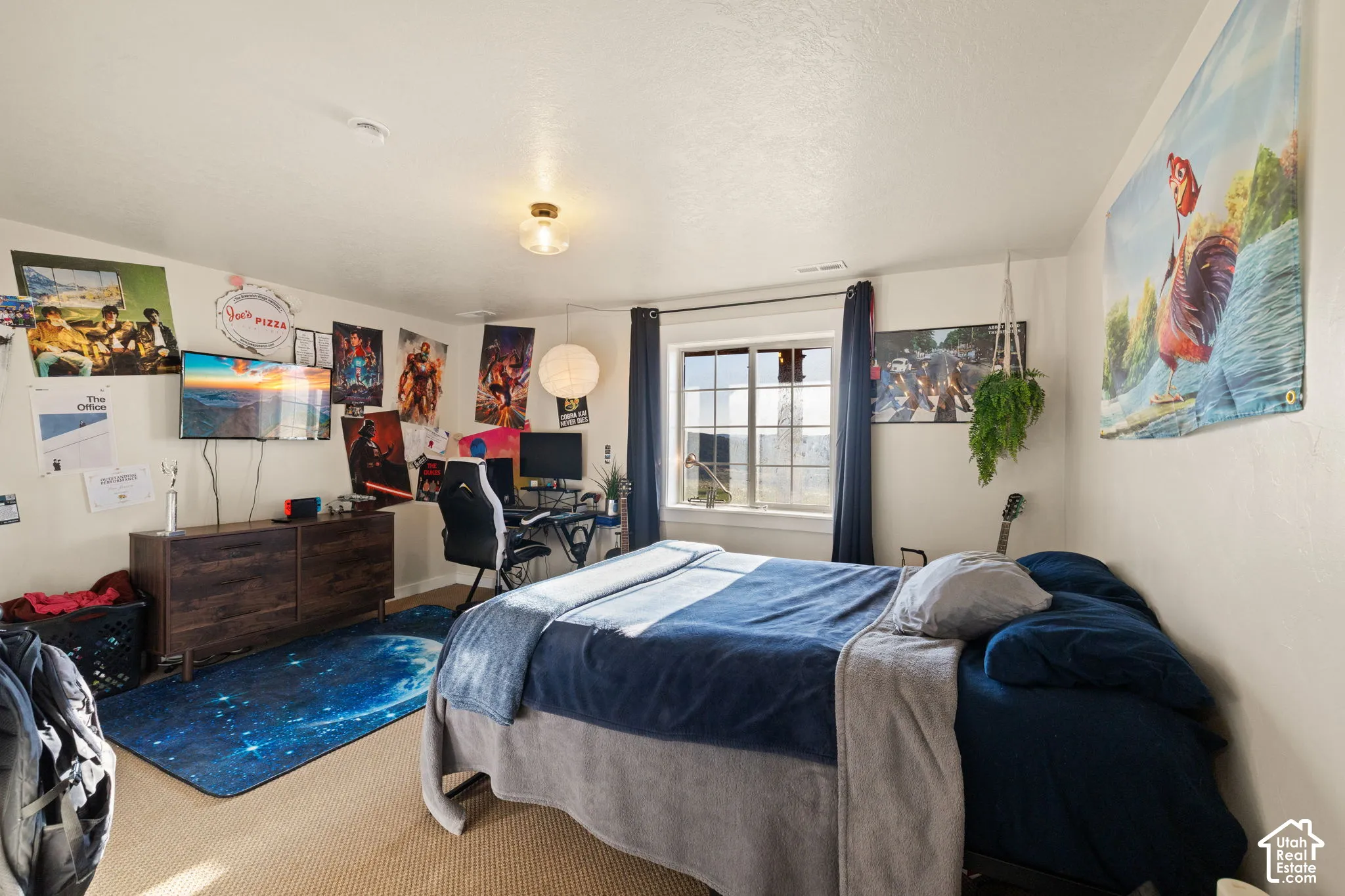 Carpeted bedroom featuring a desk