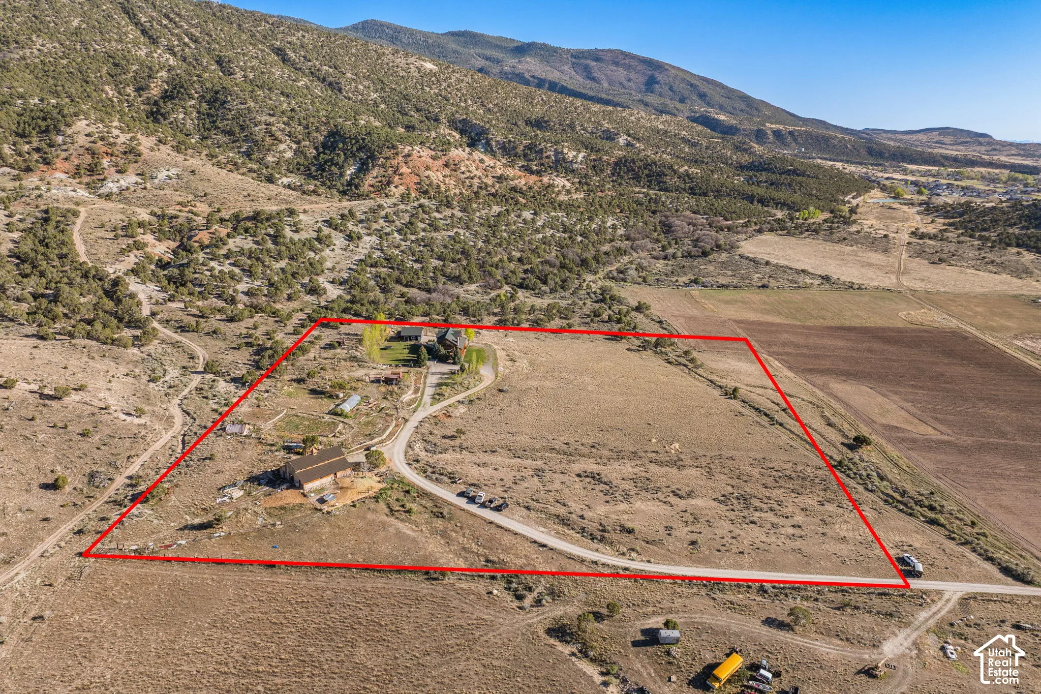 Aerial view of sparsely populated area featuring property boundaries highlighted and mountains