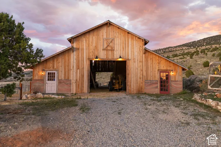 Outdoor structure at dusk featuring a barn