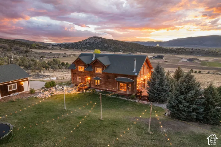Rear view of custom log home with valley and Manti Temple views