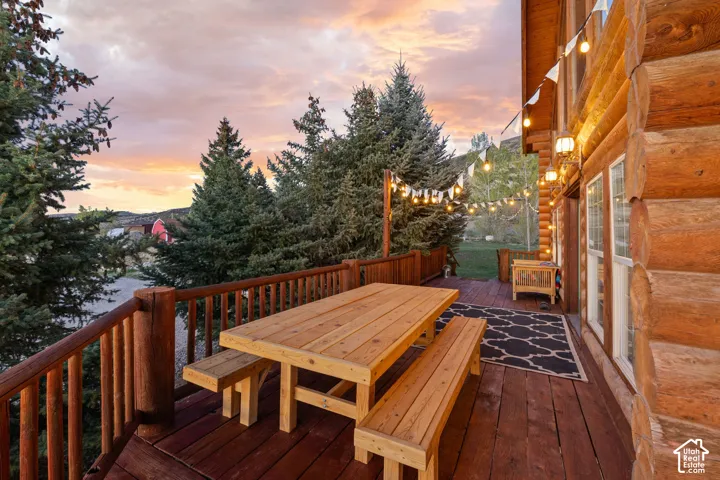 Deck at dusk featuring outdoor dining area