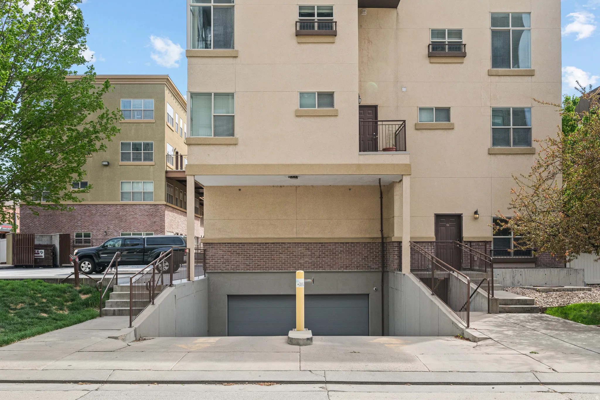 View of property with an attached garage and concrete driveway