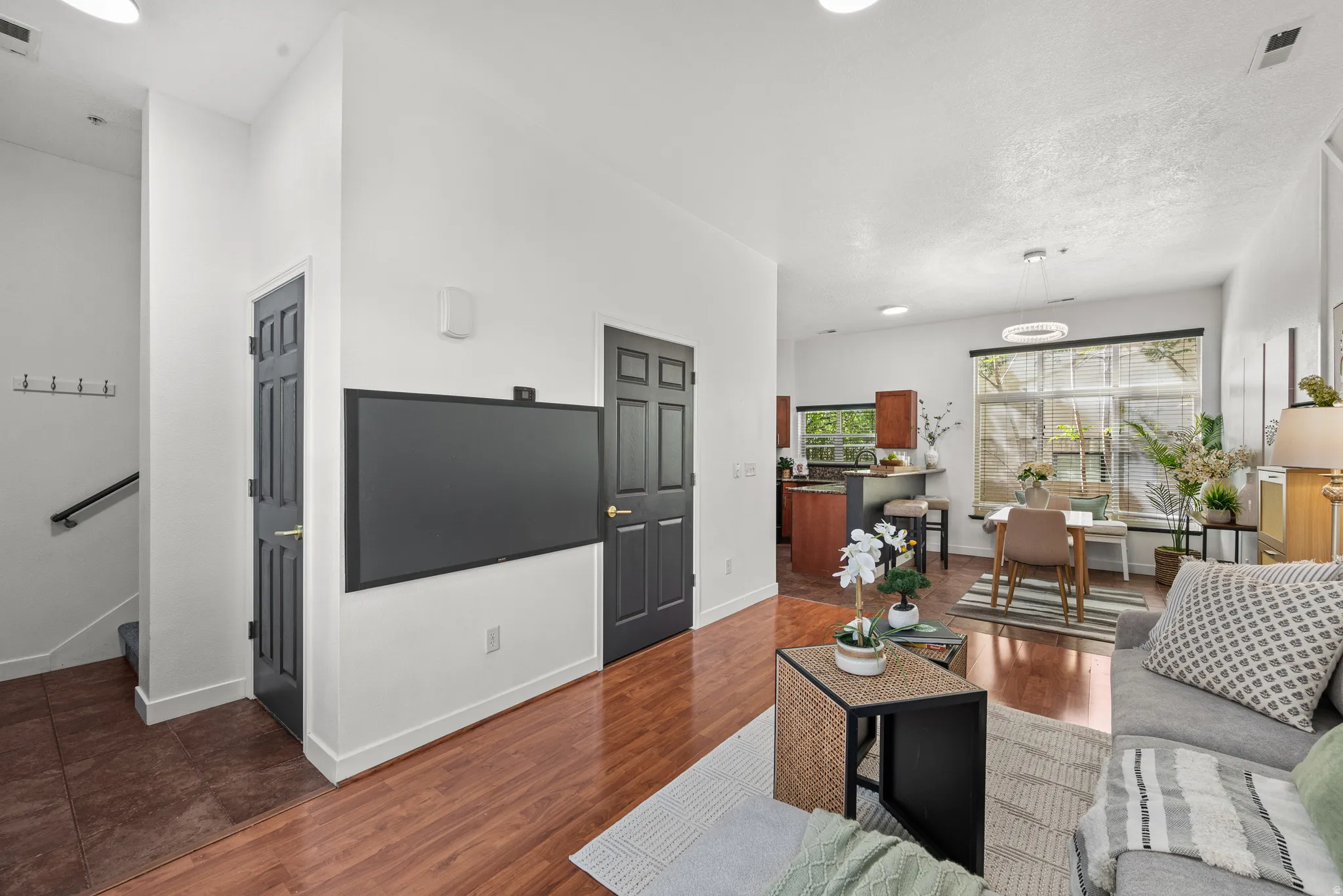 Living room with dark wood-style flooring and recessed lighting