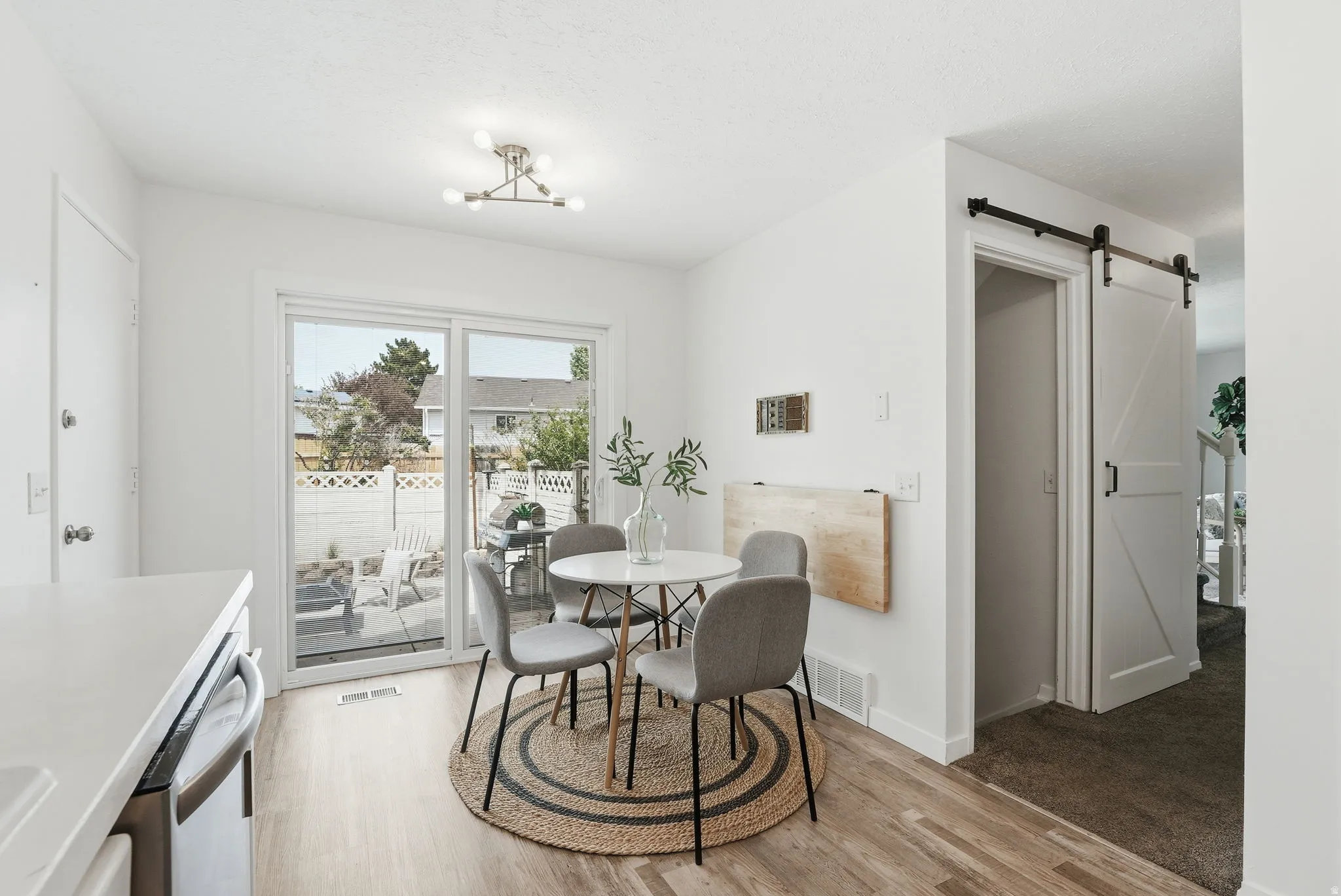 Dining space featuring a barn door and light wood-type flooring