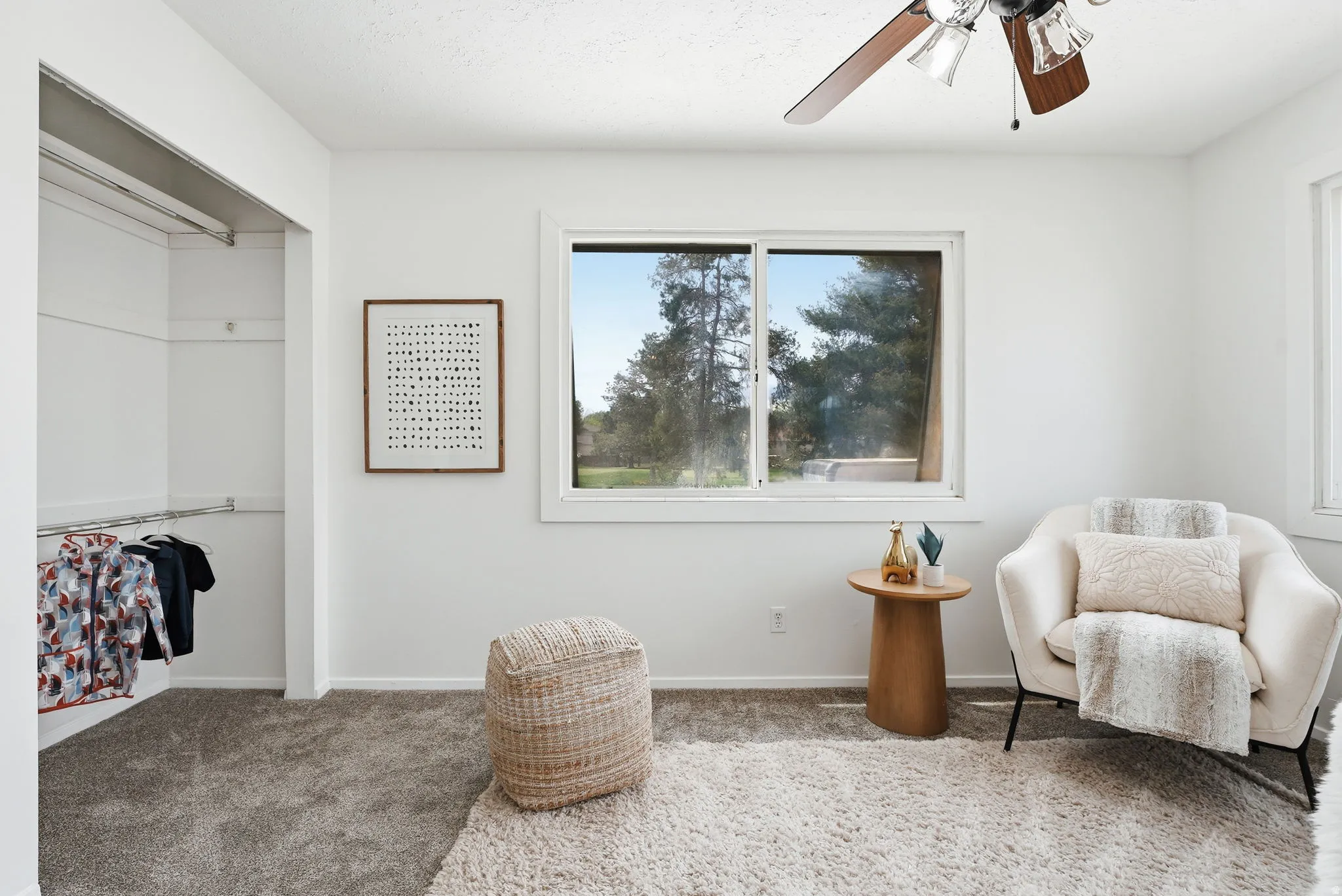 Living area featuring carpet floors and ceiling fan