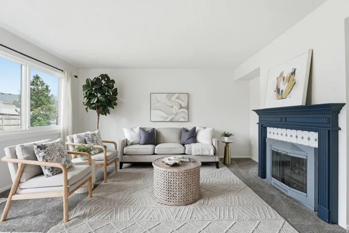 Living room with light carpet and a glass covered fireplace