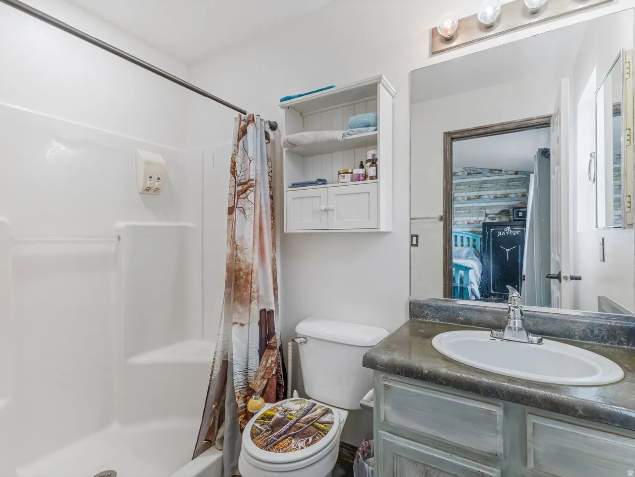Full bath featuring vanity and a shower stall