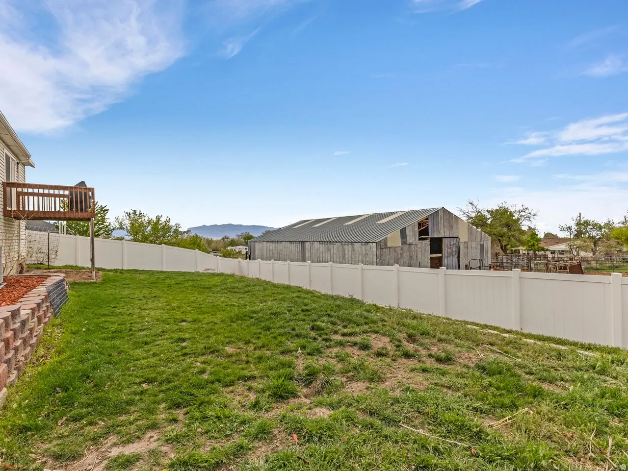 Fenced backyard featuring a mountain view