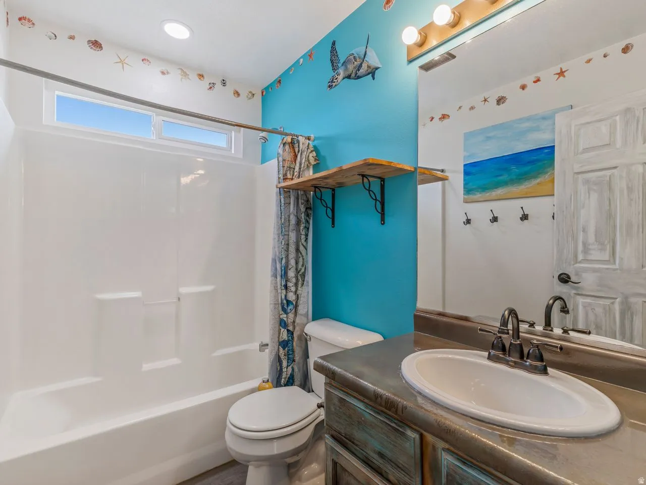 Bathroom featuring vanity and shower / bath combo with shower curtain