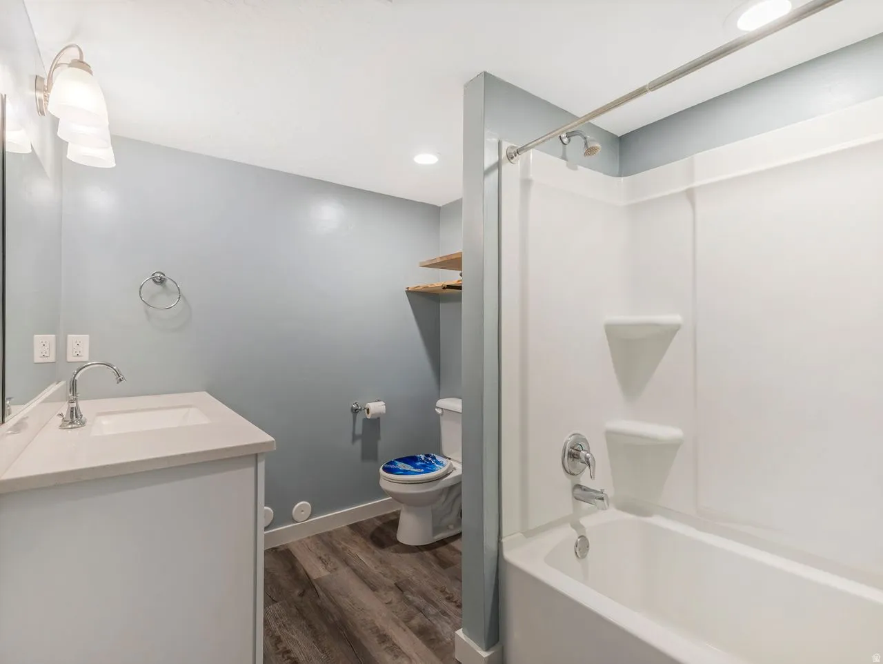 Full bathroom featuring vanity, dark wood-style floors, bathtub / shower combination, and recessed lighting