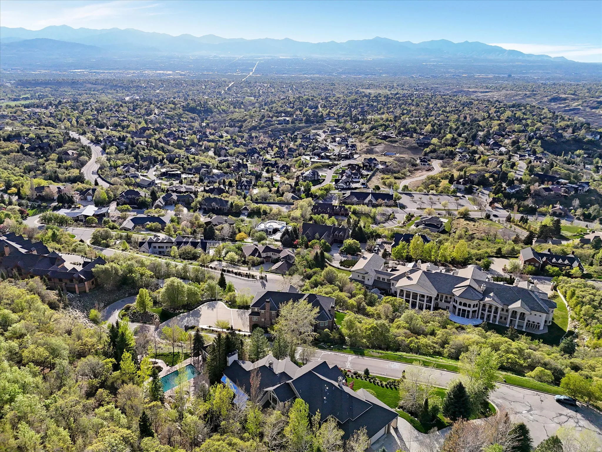 Aerial perspective of suburban area with a mountain backdrop