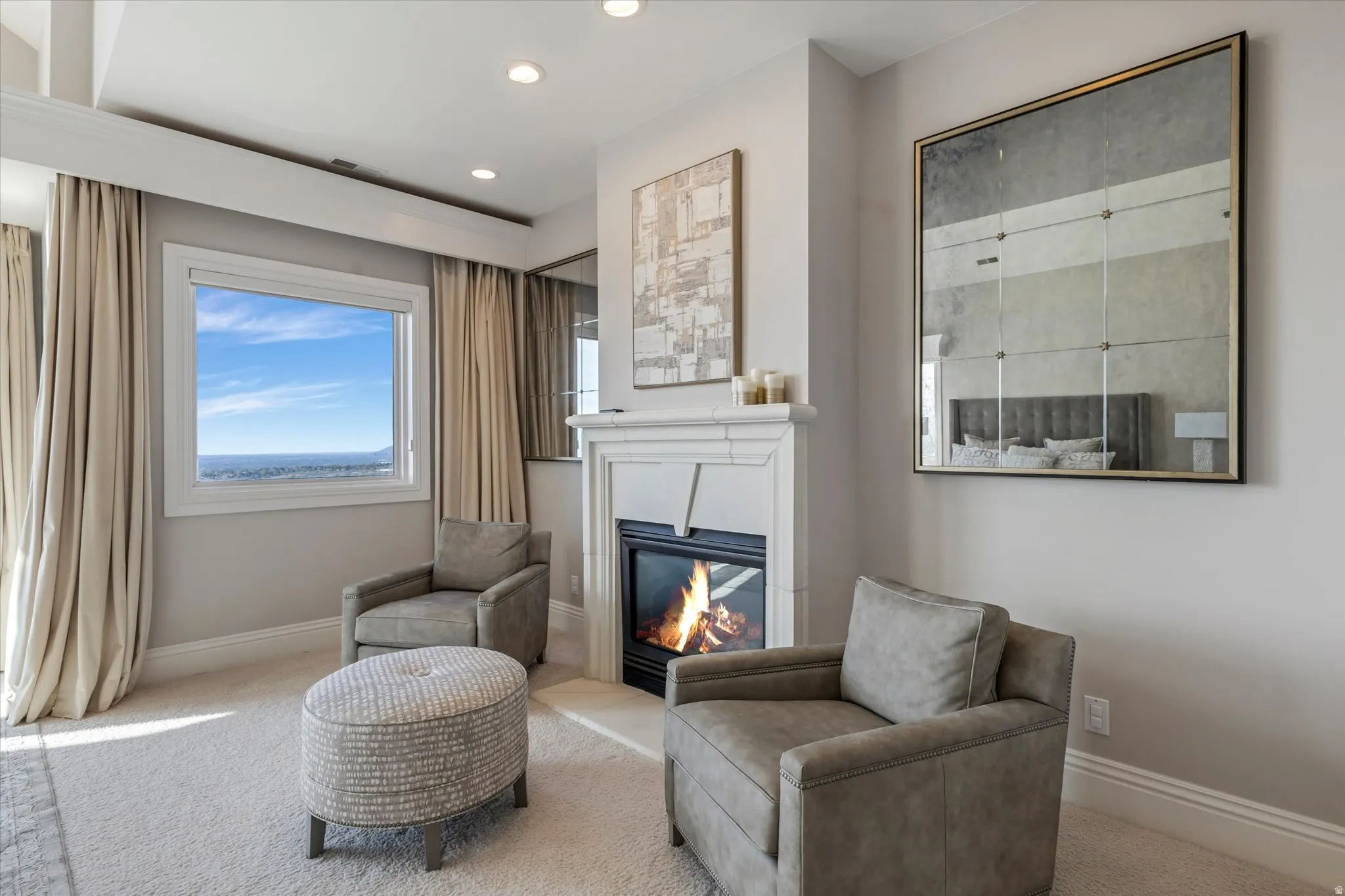 Sitting room featuring carpet floors, a glass covered fireplace, and recessed lighting
