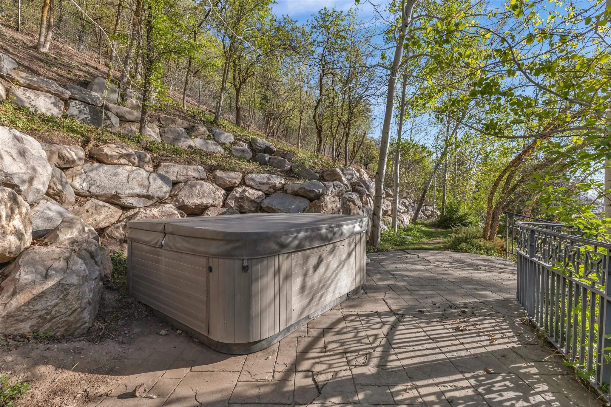 View of yard with a hot tub and a patio