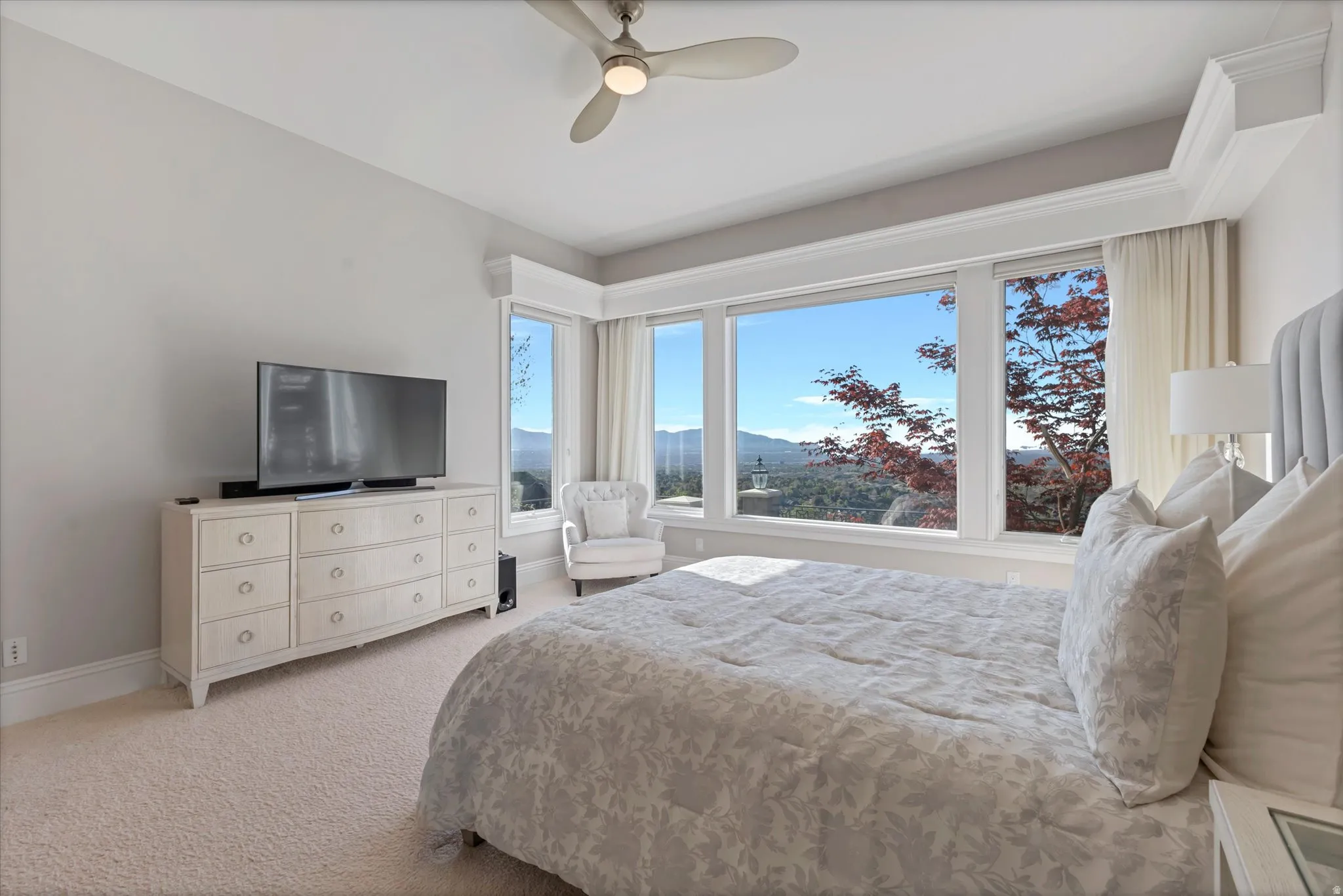 Bedroom featuring ceiling fan and light colored carpet